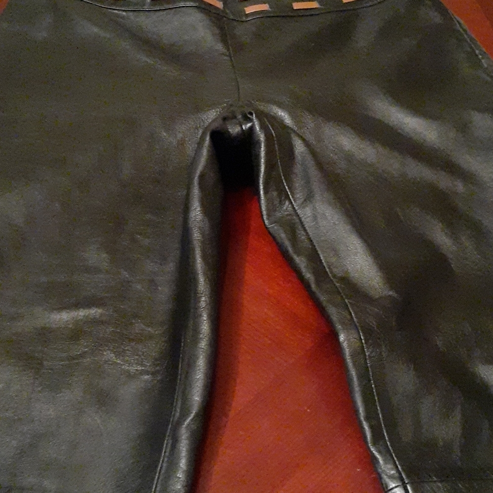 Black leather pants with zipper on the side.